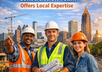 Atlanta construction team with local expertise standing at a building site, city skyline in background.